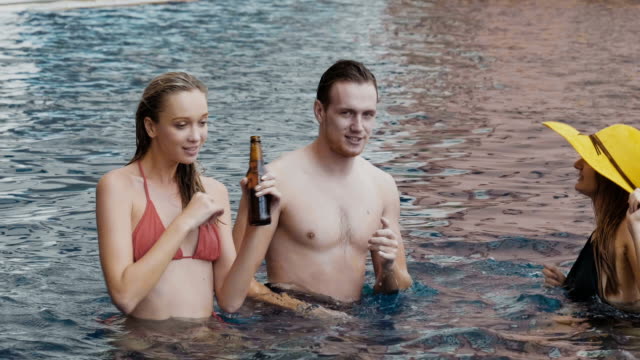 Group Of Friends On Vacation And Enjoyment Into Outdoor Pool