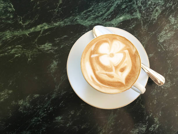 istock Attractive cappuccino with a drawing of flower 997953356