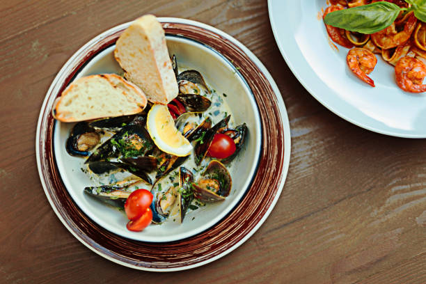istock Selective focus of mussels with tomatoes and basil 997959618