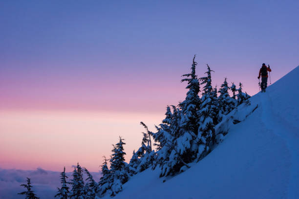 Man split boarding in the backcountry