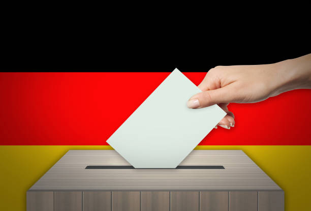 istock Man voting on elections in GERMANY front of flag 997965378