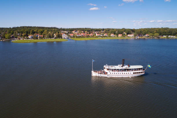 Passenger steamboat Mariefred Mariefred, Sweden - July 4, 2018: Aerial view of the white passenger steamboat Mariefred on lake Malaren near its destination Mariefred. mariefred stock pictures, royalty-free photos & images