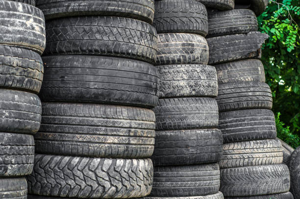 istock Old used car tires stacked in stacks 997975582