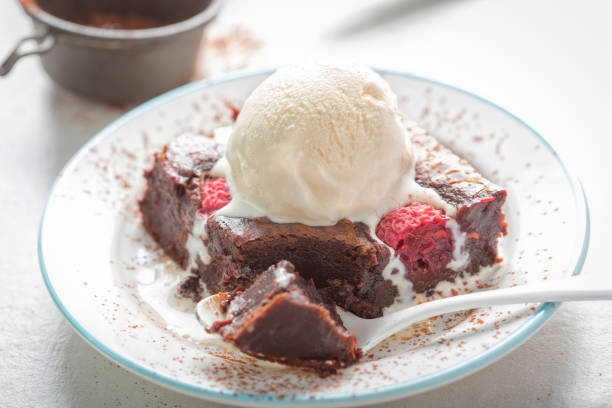 istock Raspberry chocolate brownies with vanilla ice creams 997985530