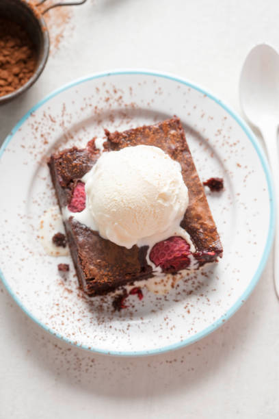istock Raspberry chocolate brownies with vanilla ice creams 997985534