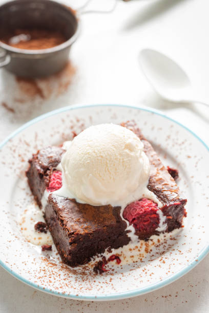 istock Raspberry chocolate brownies with vanilla ice creams 997985616