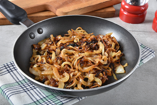 Golden brown caramelized onions in a small frying pan