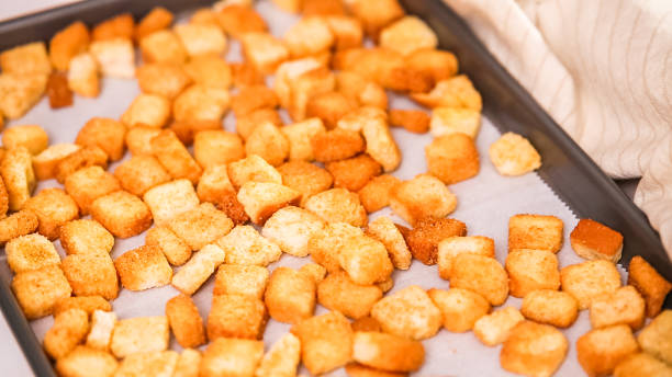istock Fresh french toast croutons on baking sheet. 997994236