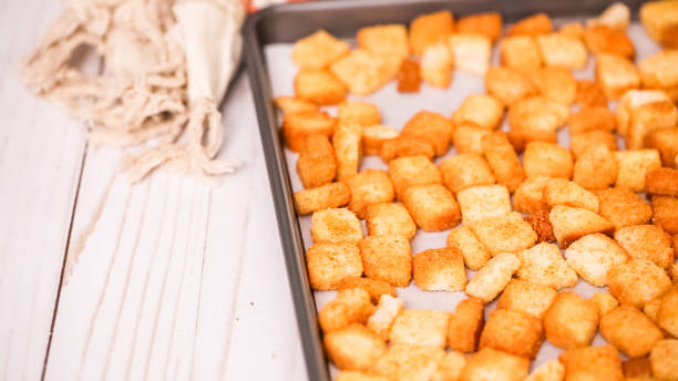istock Fresh french toast croutons on baking sheet. 997994296