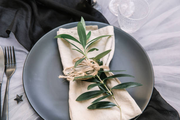 istock Linen napkin with olive branch on plate. Rustic wedding table setting 998005566