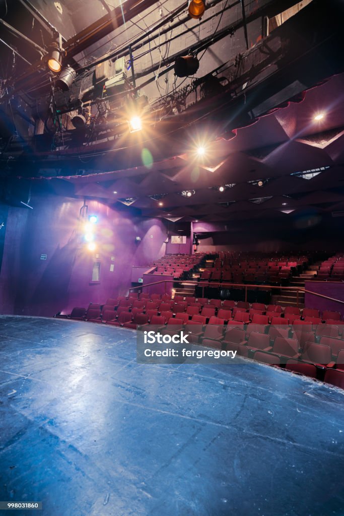 Theater seats seen from stage Theater stage with dramatic lighting Stage Theater Stock Photo