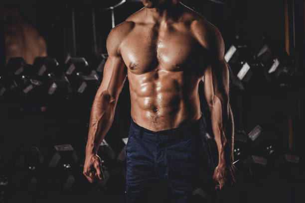 Muscular Man Standing In The Gym Strong Muscular Men Standing At The Gym abdominal muscle stock pictures, royalty-free photos & images