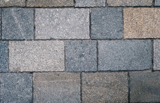 istock Pavement tiles, texture background. Gray Square Pavement. Seamless Tileable Texture. Old paving tiles background texture 998038790