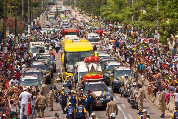 Road Cirio of Nazareth Belém, PA, Brazil - October 11th, 2013: Image of Our Lady of Nazareth (Nossa Senhora de Nazaré), in the road procession on the eve of the Cirio of Nazareth, considered the largest Catholic event of the world. A crowd follows the image, which is called 'pilgrim saint' because there are many transfers on the eve of the official day of Cirio. cirio de nazare stock pictures, royalty-free photos & images