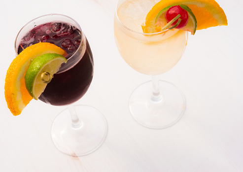 Photograph of a glass of sangria and a glass of chilled, iced wine.