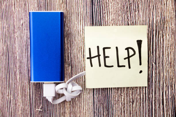 istock USB cable attached with Power Bank and piece of chart with the word Help is present.Making something easier, possible or available to serve someone is mentioned in the image. 998058808