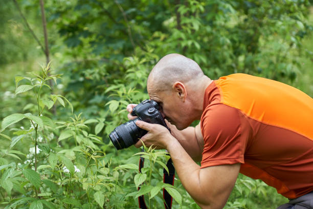 istock Photographer shooting a macro scene 998078070