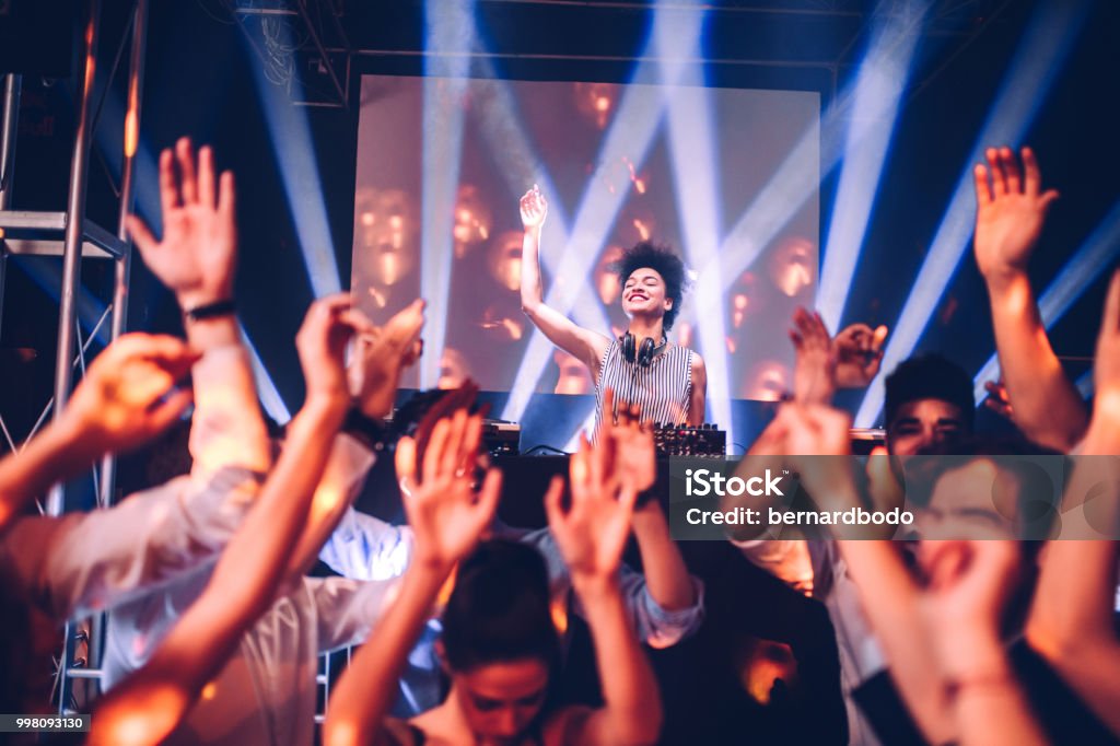 Are you ready?! Shot of a female DJ playing music in the club DJ Stock Photo