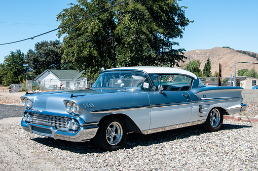 Bradley, California, United States - September 23, 2017:  A beautifully restored 1958 Chevrolet Impala painted in classic two tone blue and white with period style mag wheels displayed at the annual Hot Rod Social  in Bradley California