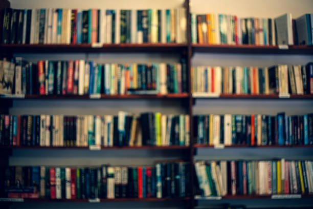 istock Shelves with books in a blurred background. Learning concept with library literature on the shelves. Abstract colorful blurred background with books. 998098356