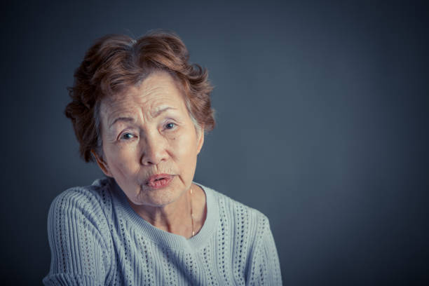 Asian senior woman serious face in studio