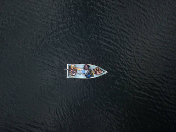 Aerial View of Fishermans Fishing From a Boat on Lake Aerial View of Fishermans Fishing From a Boat on lake in forest, Quebec, Canada quebec photos stock pictures, royalty-free photos & images