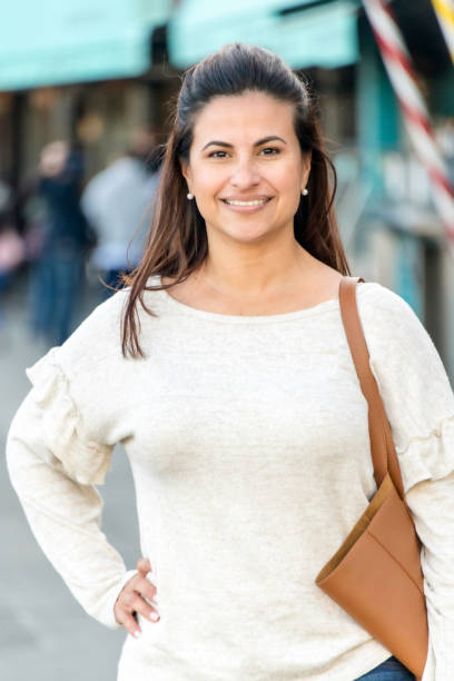 istock Smiling mature woman posing with her hand on her hip 998124536