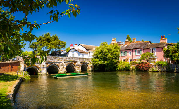Bridge over the River Avon Christchurch Dorset England A stone bridge spans the River Avon Christchurch Dorset England on a hot summer day new forest stock pictures, royalty-free photos & images