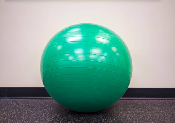istock Green exercise ball on an isolated background at the gym 998133594