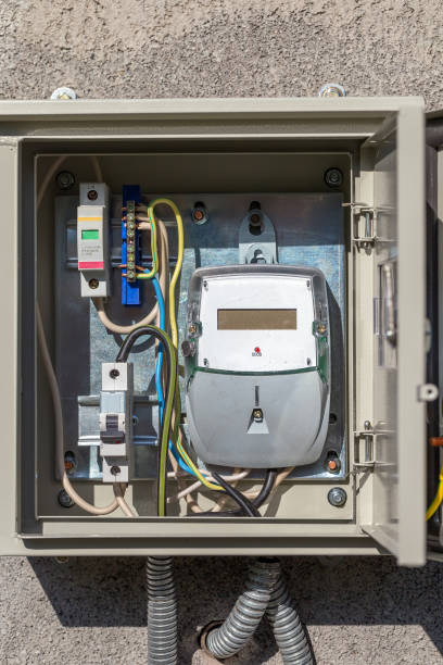 istock The electricity meter in a protective metal casing on a stone wall 998176998