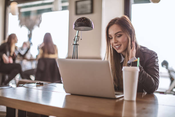 istock Young woman with computer in cafe 998193106