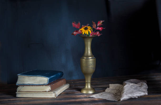 istock Dark still life with vase and flowers 998217222