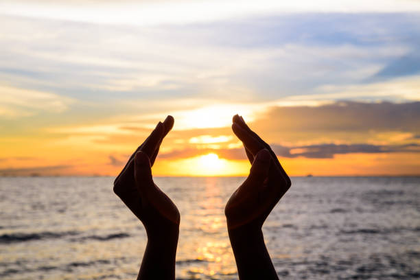 istock Woman hands holding the sun during sunrise or sunset. 998217704