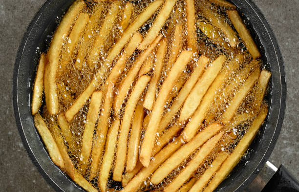 frying french fries frying french fries in a pan with oil, top view fried potato stock pictures, royalty-free photos & images