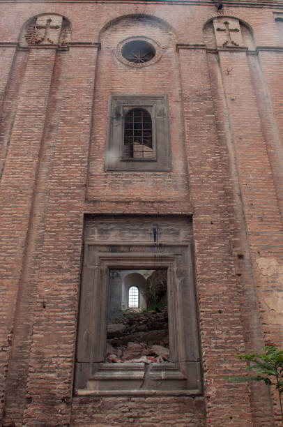 istock Old crumbling brick facade with windows and balcony 998234512