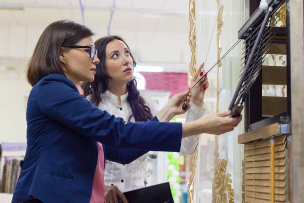 Women in the store choose blinds for windows.
