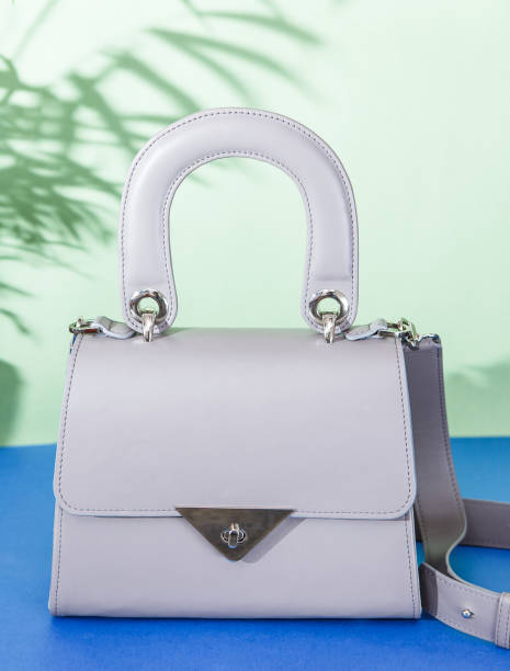 istock Fashion grey bag on dark blue background 998256712
