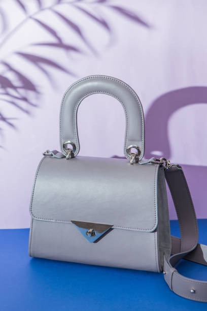 istock Fashion grey bag on dark blue background 998260290