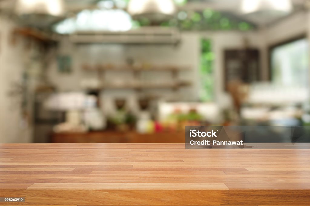 Empty of the wood table top on a blur of interior coffee cafe background.For montage product display or design Table Stock Photo