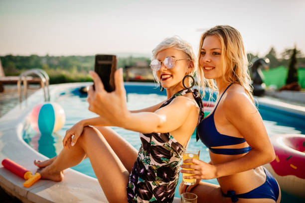 Having fun with friends at the swimming pool in summer