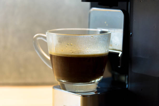 istock espresso machine with hot coffee in glass for refreshment 998274822