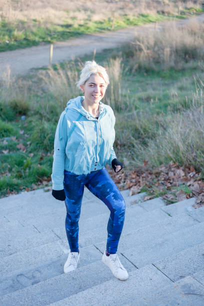 istock Active cheerful blonde pausing after a run in a park on a sunny day 998276722