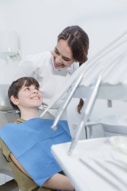 istock Dentist examining little boy's teeth in clinic 998279172