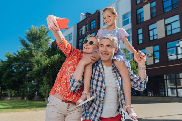 istock Delighted positive woman holding a smartphone 998285666