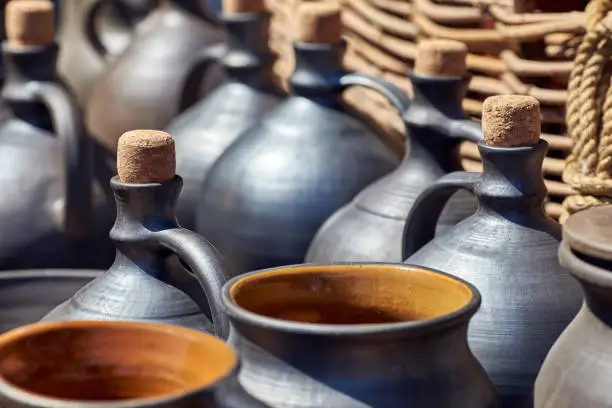 A set of jugs, bottles and pots for wine or oil. Antique vessels and pitchers on the shelves in the kit.