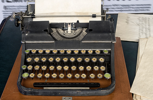 Old vintage typewriter and a blank sheet of paper inserted.