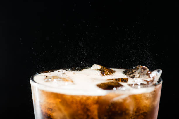 istock Ice cola with splashing CO bubbles in a glass 998304420