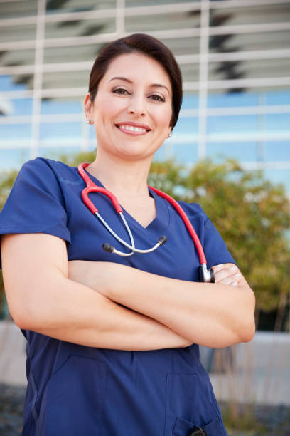 istock Smiling Hispanic female healthcare worker outdoors, vertical 998312498