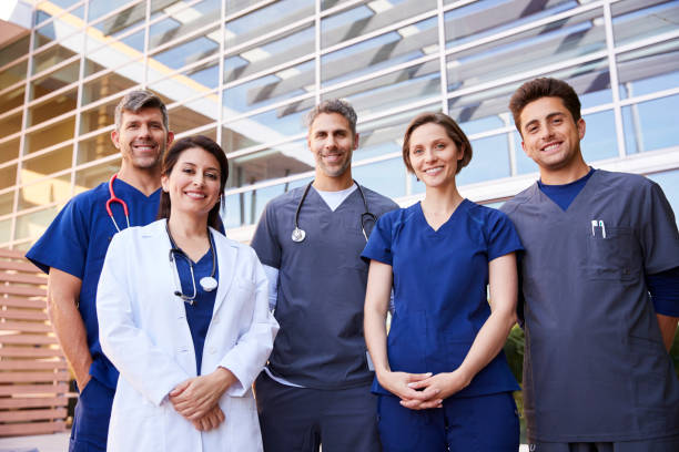 istock Five healthcare colleagues standing outdoors, group portrait 998313300