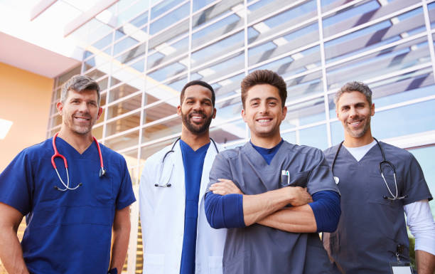 istock Male healthcare colleagues standing outdoors, low angle 998313306